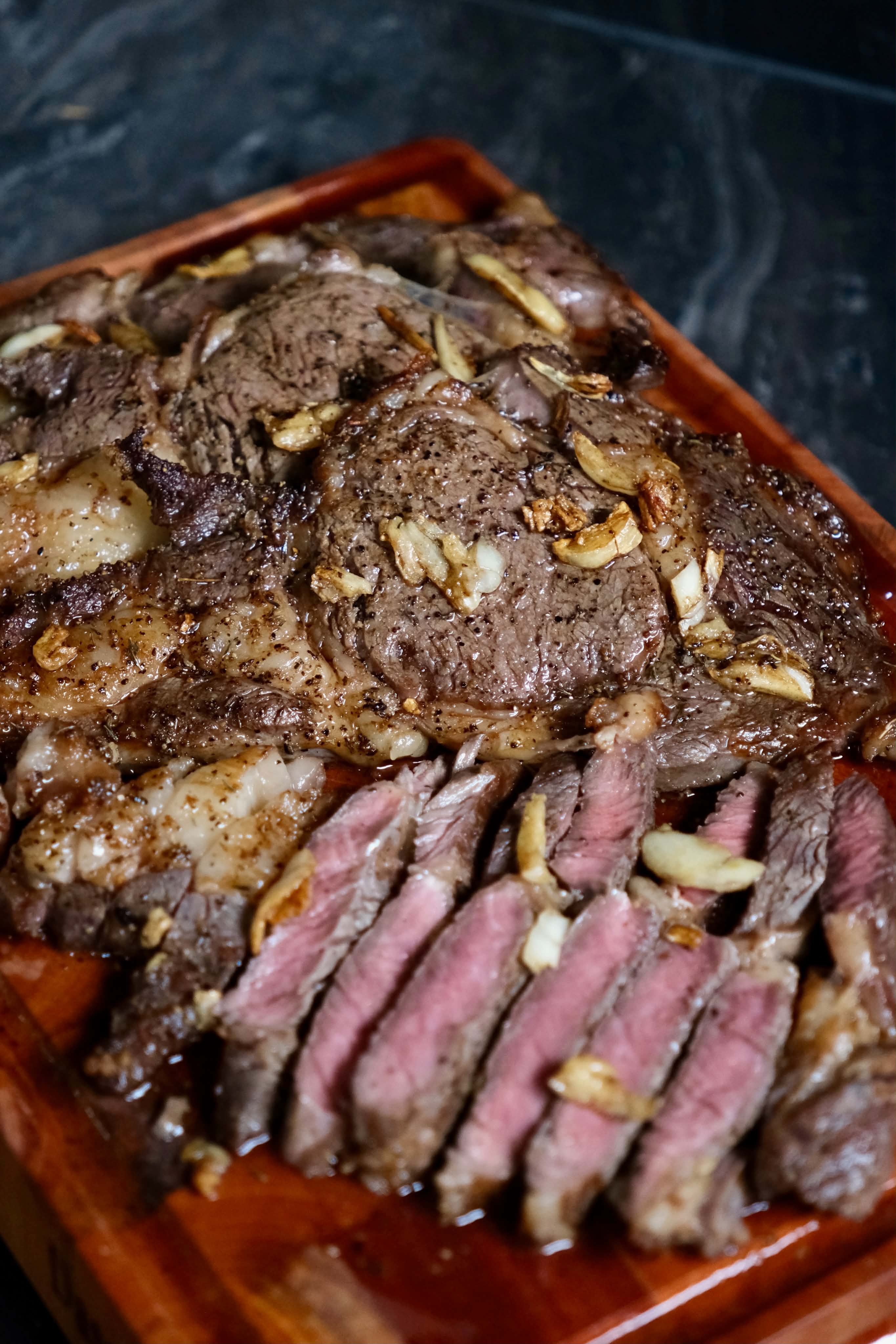 Butter-aged ribeye from Daily Steak PH, seared and sliced on a wooden board